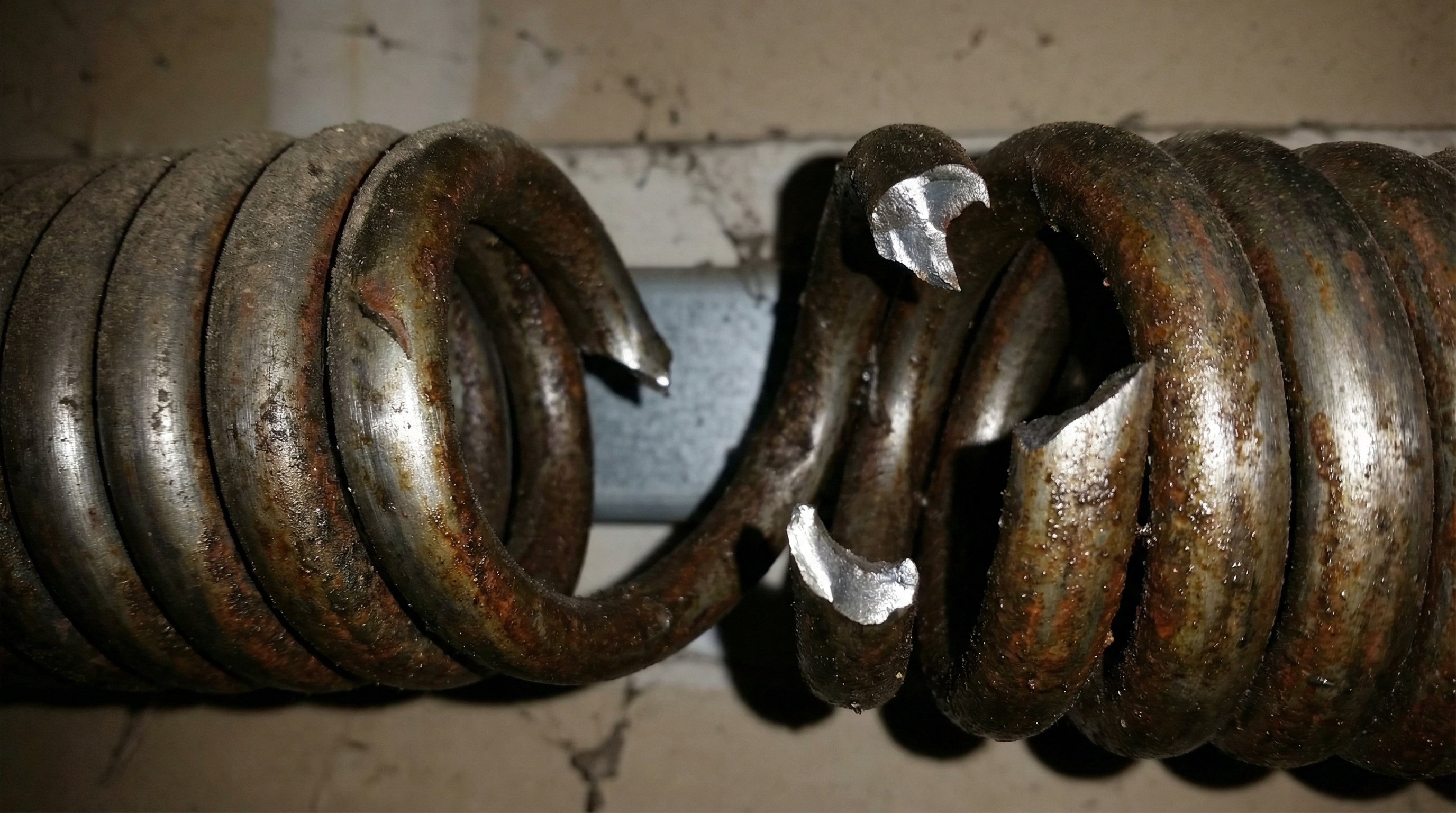 Broken Garage Door Spring Close Up Showing Damaged Coil
