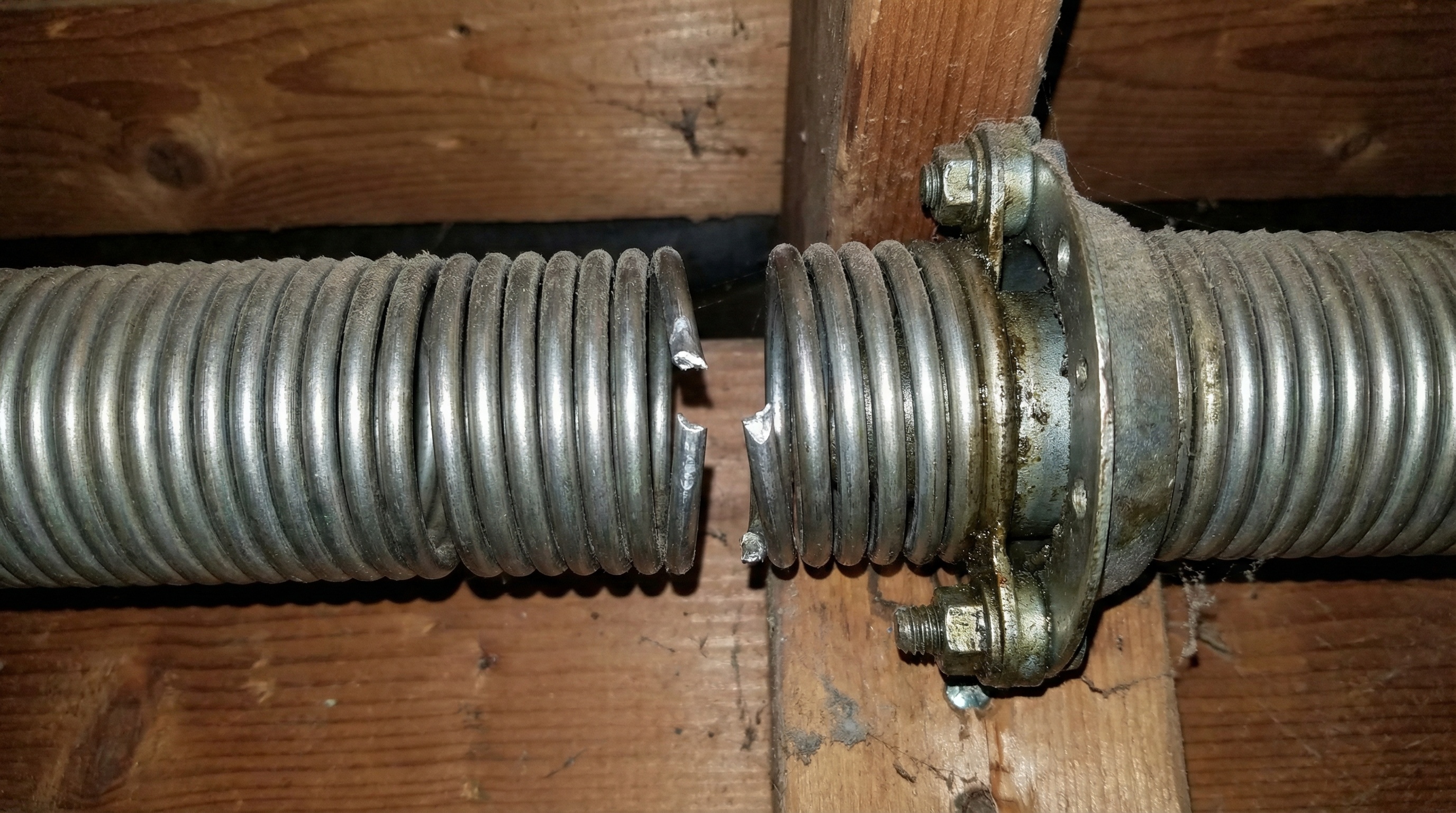Broken garage door spring requiring repair