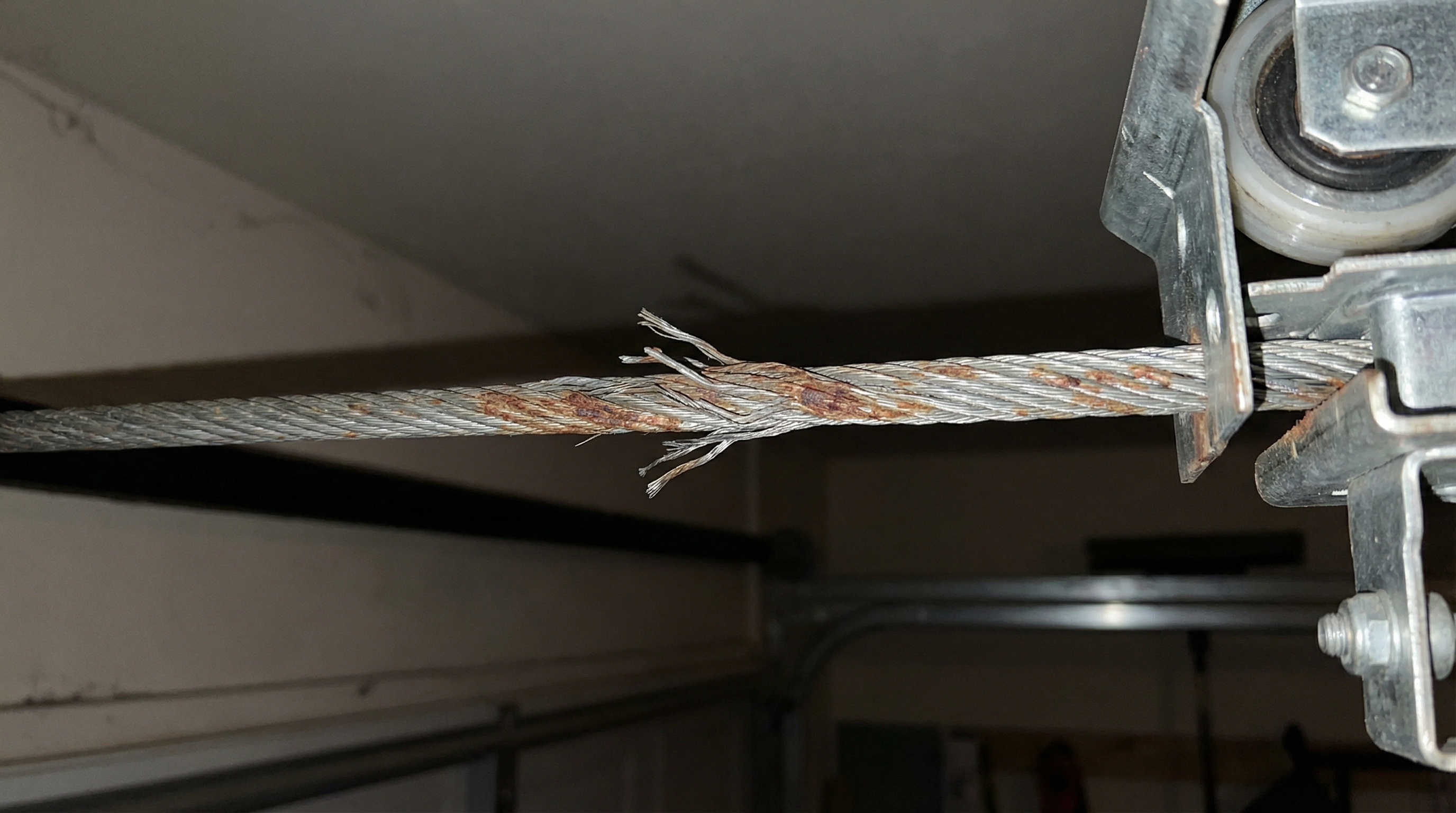 Garage door cable warning signs and damage indicators