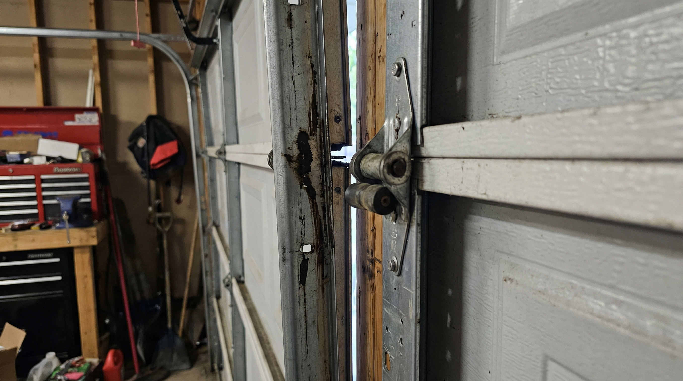 garage door tracks showing wear patterns and misalignment damage