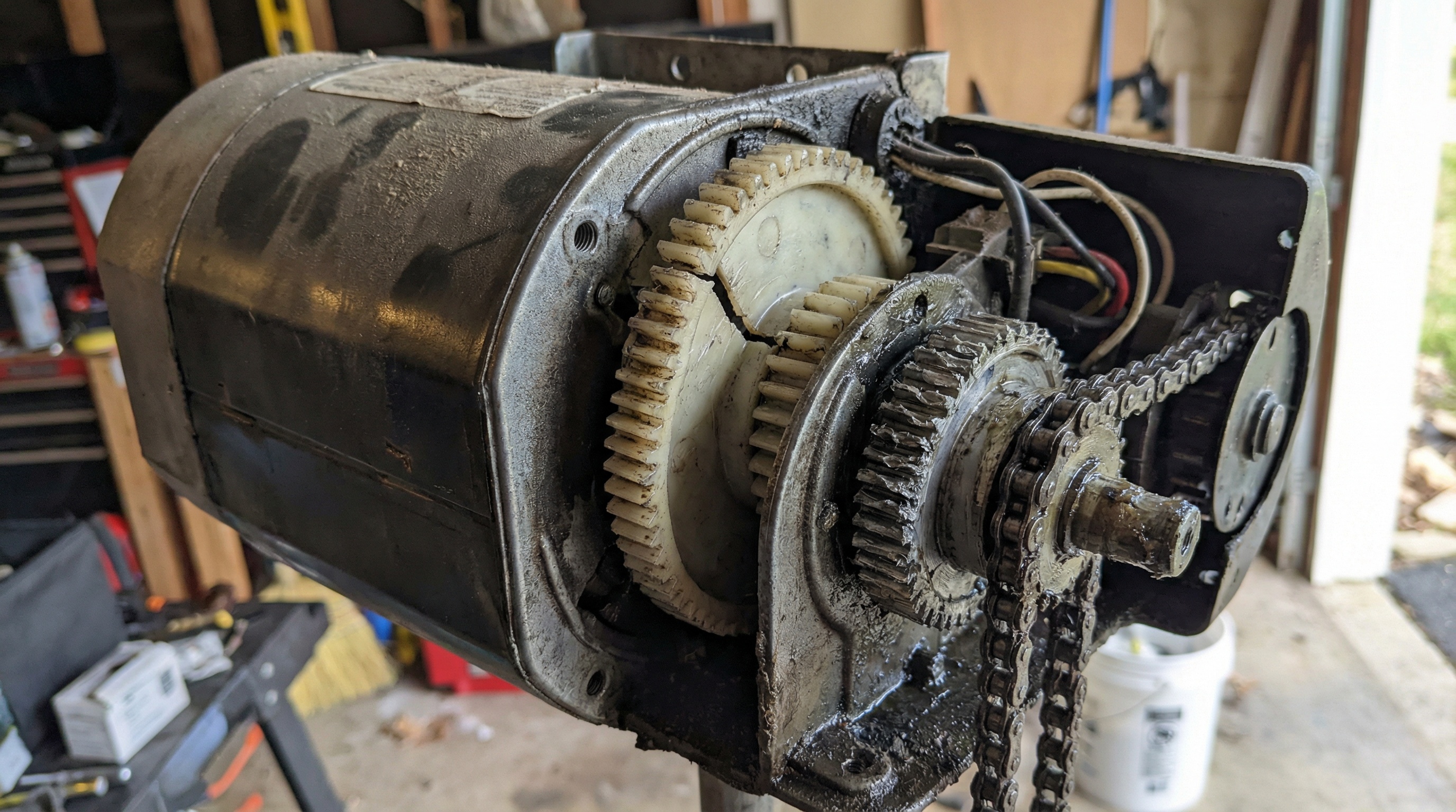 Close-up of garage door opener motor showing worn gears