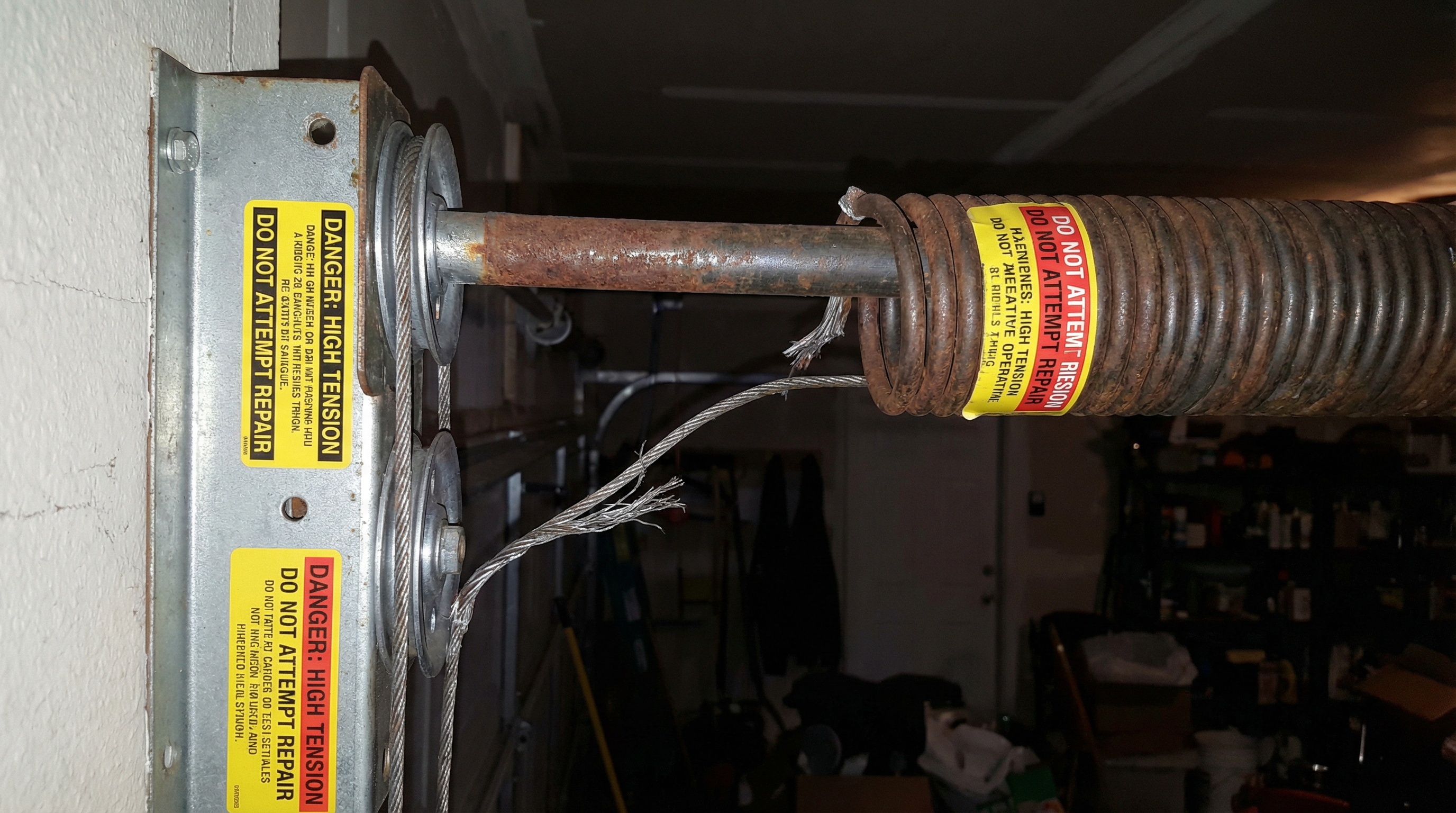 Broken garage door spring warning signs